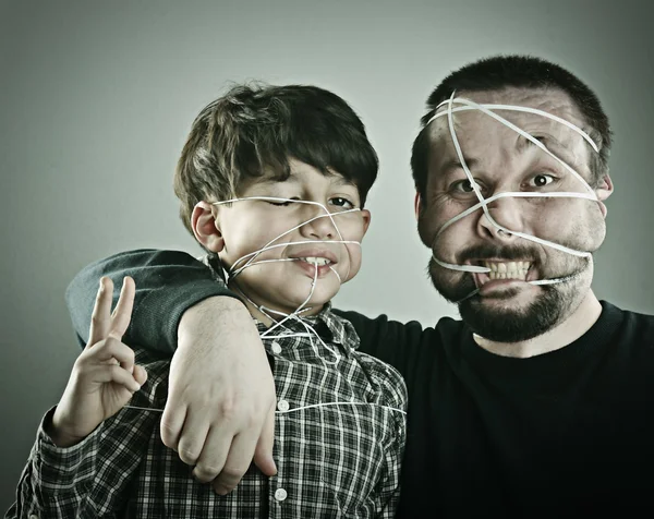 Conceptual portrait of mad father and son — Stock Photo, Image