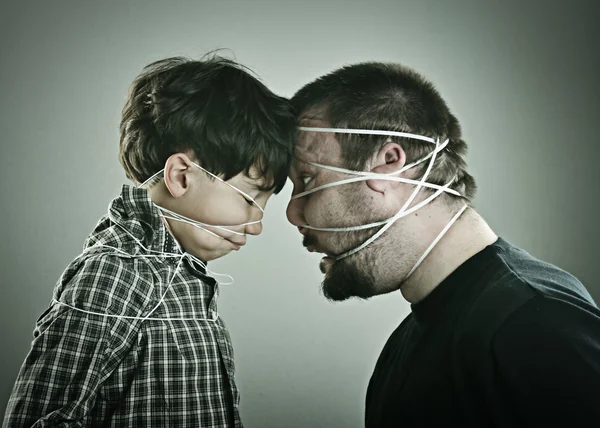 Conceptual portrait of mad father and son — Stock Photo, Image