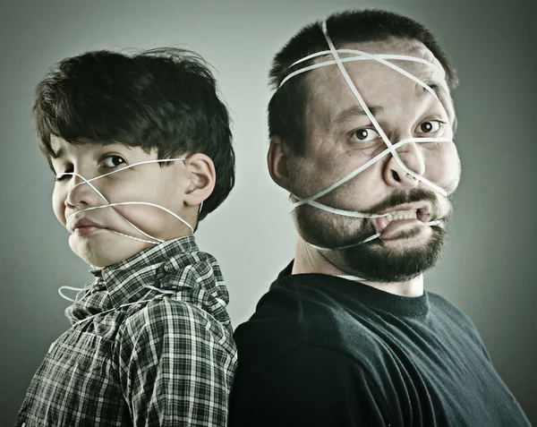 Conceptual portrait of mad father and son — Stock Photo, Image