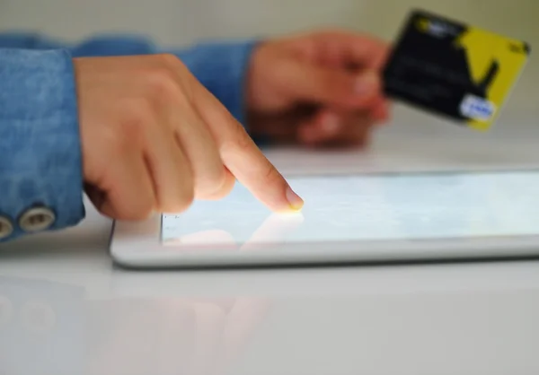Human hand on tablet pc and credit card