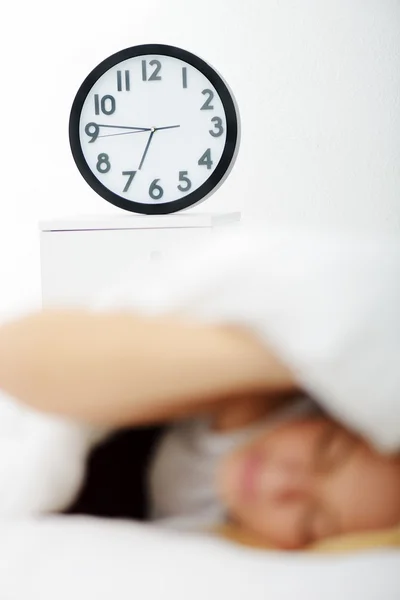 Femme au lit dans la chambre à coucher avec montre — Photo