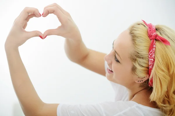 Happy blonde girl on bed in bedroom — Stock Photo, Image