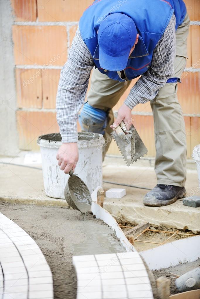 Worker making sidewalk pavement