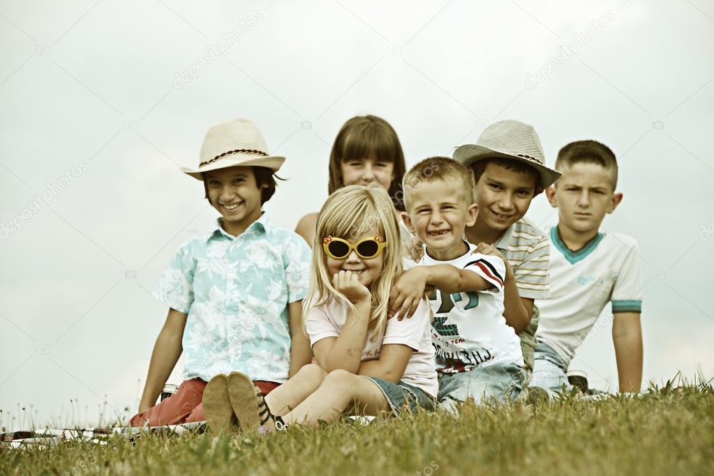 Happy kids on summer grass meadow