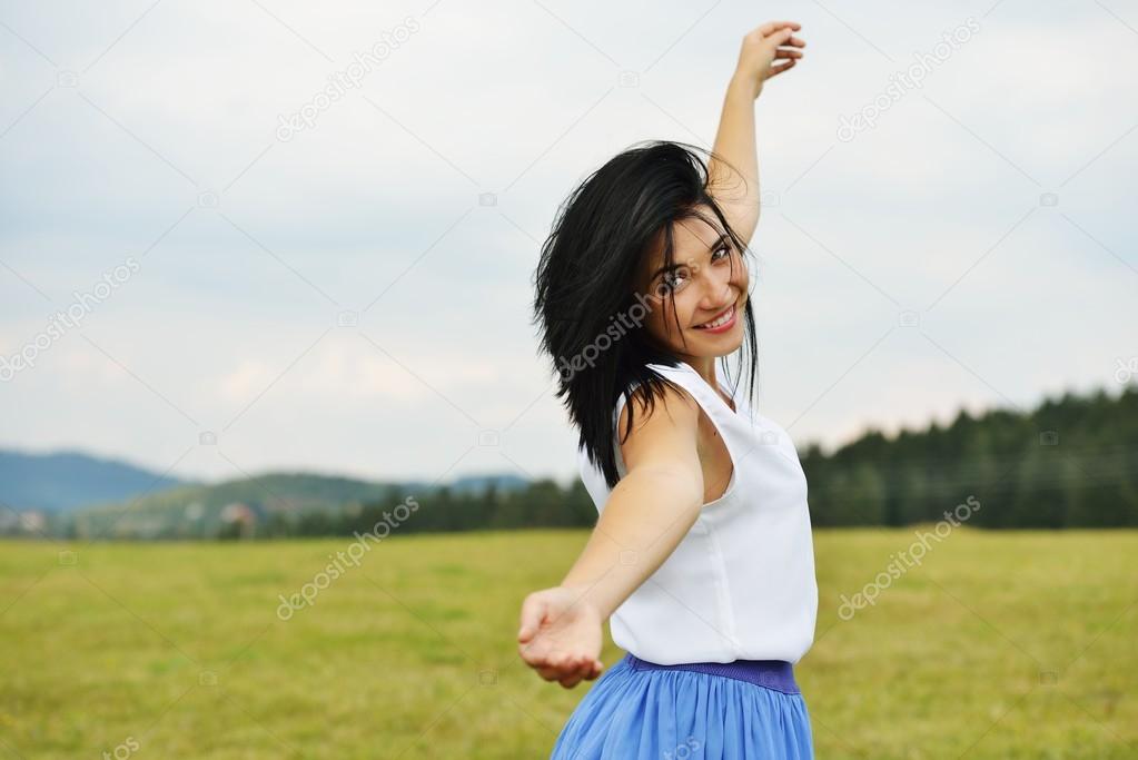 Young person having relaxed happy time on meadow in nature