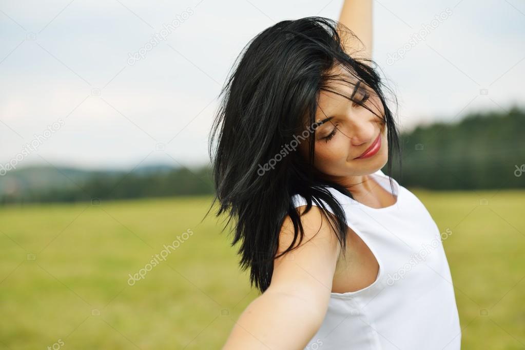 Young person having relaxed happy time on meadow in nature