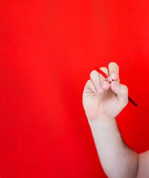 Hand painting wall in red — Stock Photo, Image