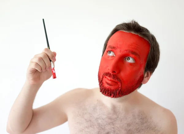 Painting in red man's face — Stock Photo, Image
