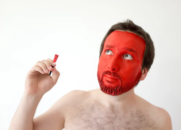 Painting in red man's face — Stock Photo, Image