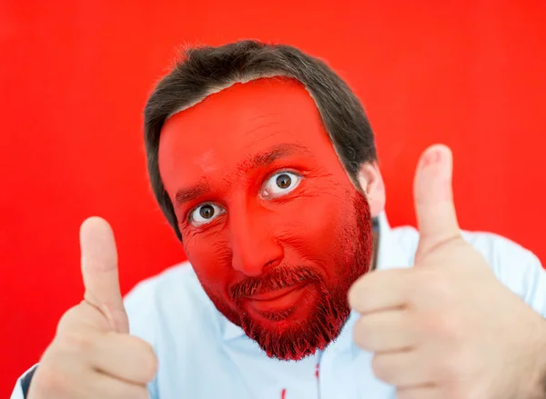 Young man portait with red painted face — Stock Photo, Image