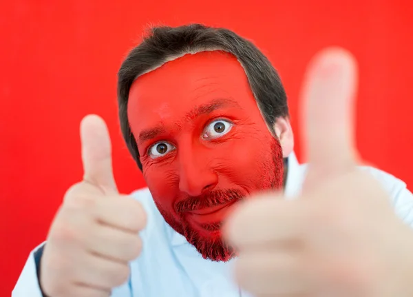 Young man portait with red painted face — Stock Photo, Image