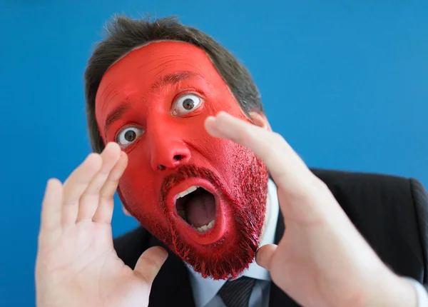 Young man portait with red painted face — Stock Photo, Image