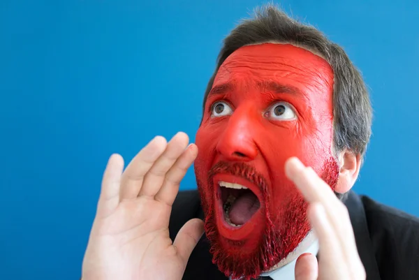 Young man portait with red painted face — Stock Photo, Image