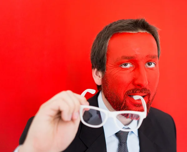 Jonge man portret met rode geschilderde gezicht — Stockfoto