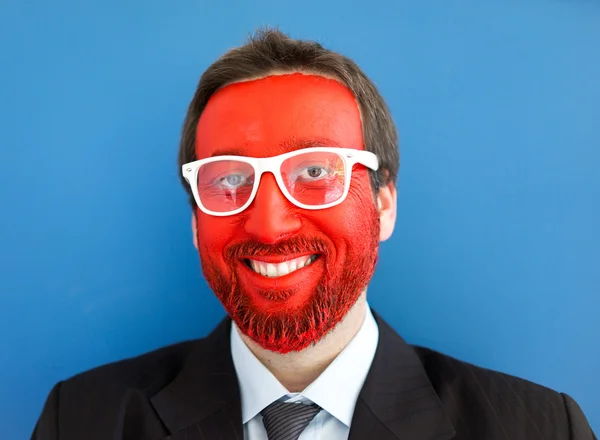 Young man portait with red painted face — Stock Photo, Image