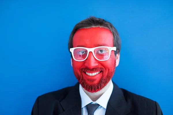 Young man portait with red painted face — Stock Photo, Image