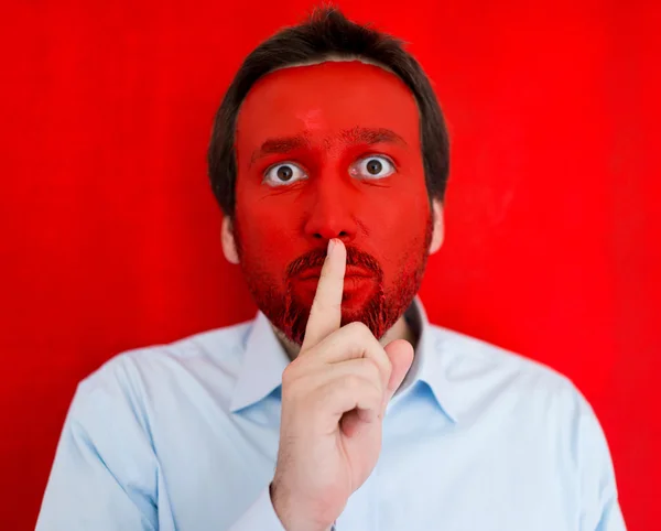 Young man portait with red painted face Stock Photo