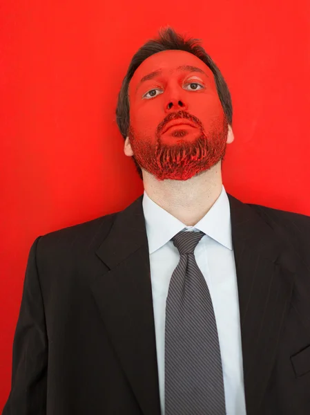 Young man portait with red painted face — Stock Photo, Image