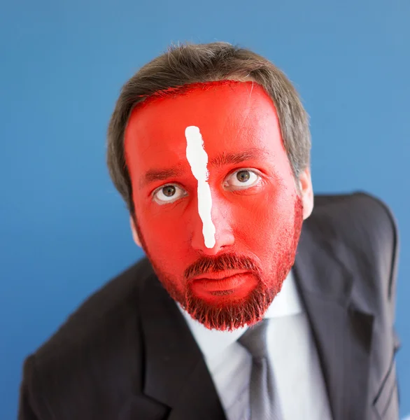 Ung man porträtt med röda målade ansikte — Stockfoto