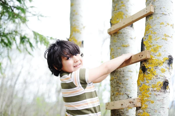 Happy kid having fun climbing on ladder — Stock Photo, Image