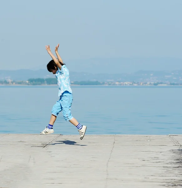 Chlapec na krásné jezero doku — Stock fotografie