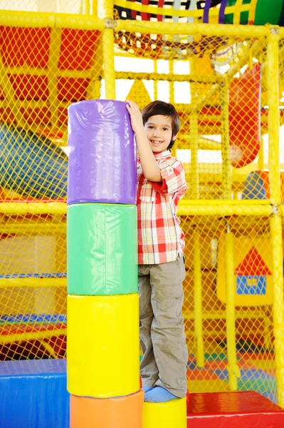 Kid playing on colorful kindergarden playground — Stock Photo, Image