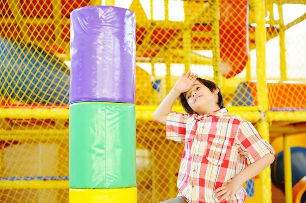 Kid playing on colorful kindergarden playground — Stock Photo, Image