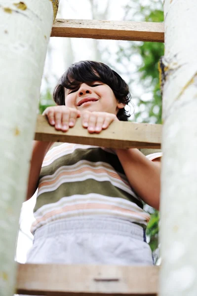 Happy kid having fun climbing on ladder — Stock Photo, Image