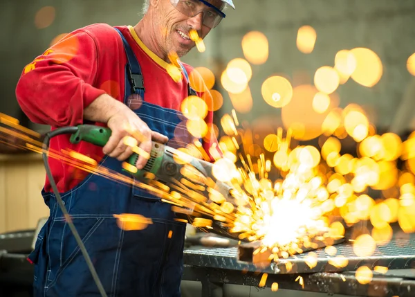 Worker cutting iron with professional tool — Stock Photo, Image