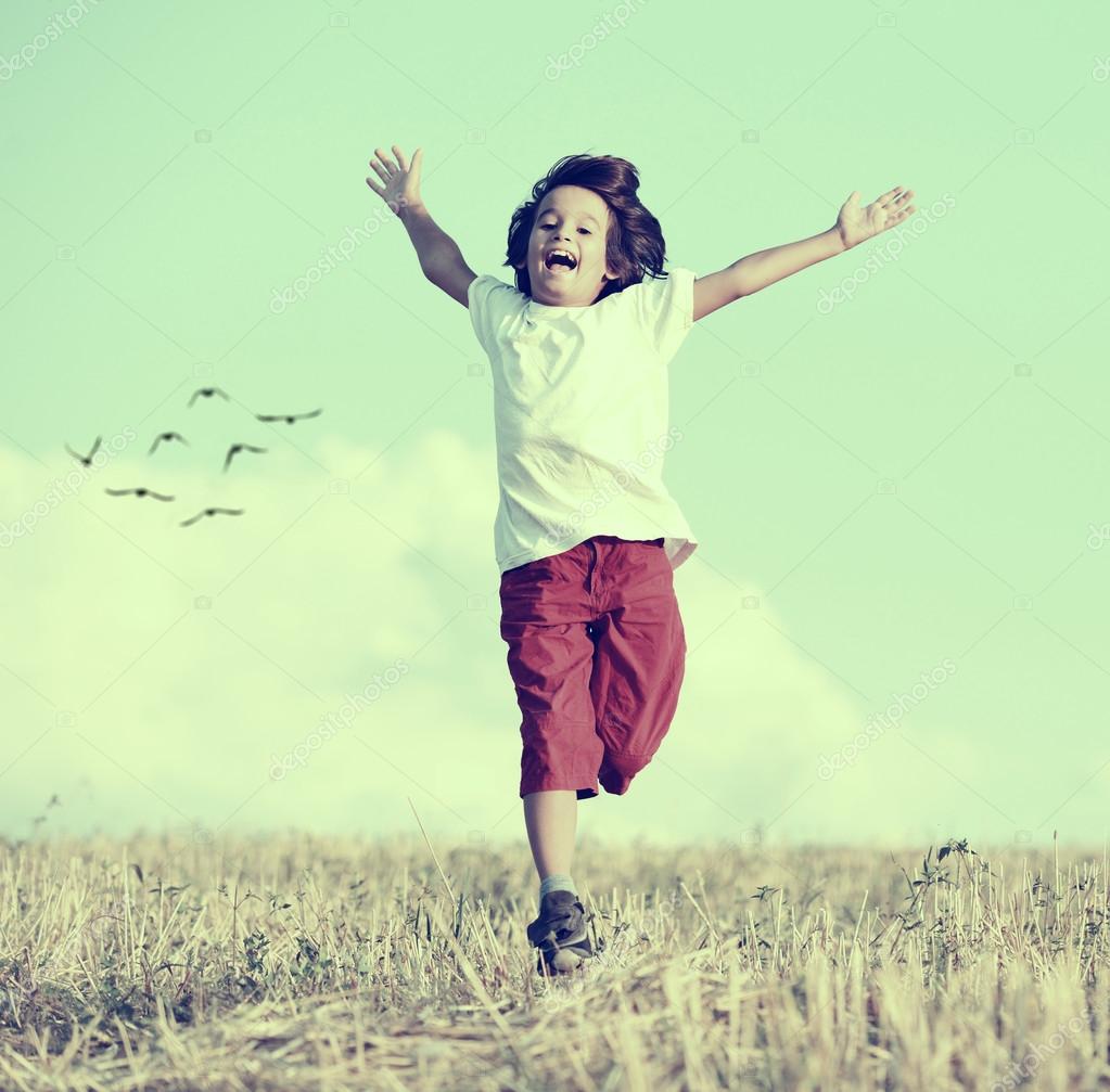 Little boy running feeling happiness Stock Photo by ©zurijeta 99418482