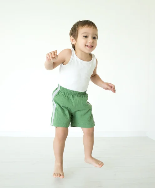 Adorable little boy at home jumping — Stock Photo, Image