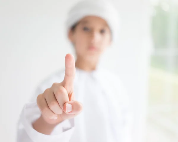 Cute Arabic kid pointing with finger — Stock Photo, Image