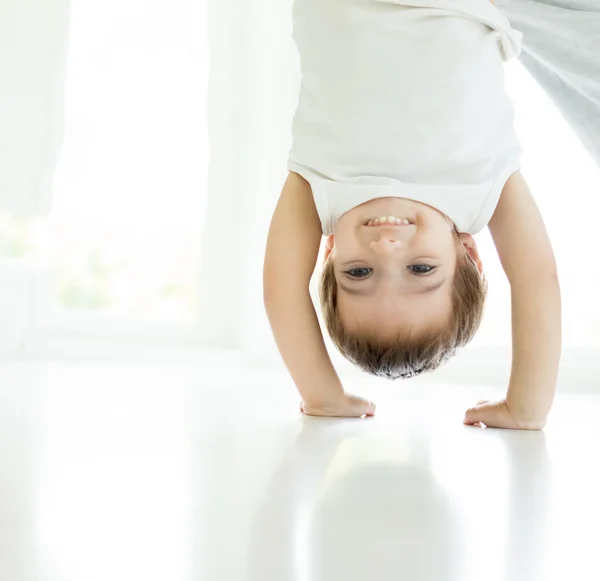 Happy little child upside down — Stock Photo, Image