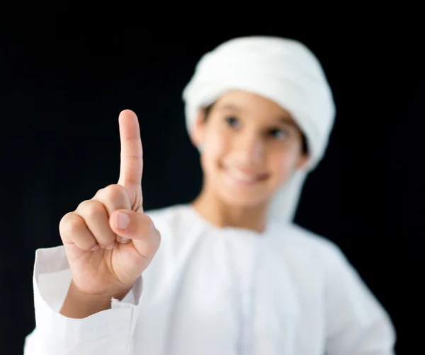 Cute Arabic kid pointing with finger — Stock Photo, Image