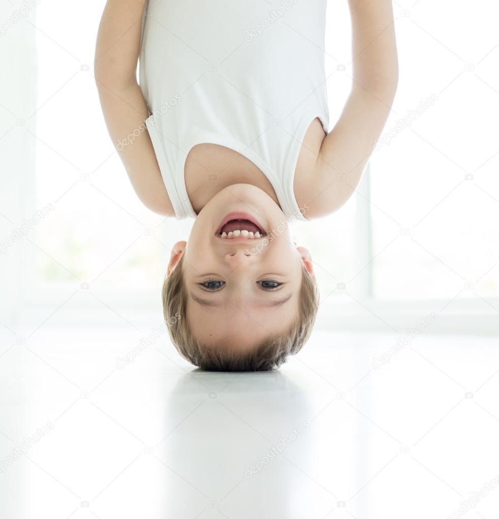 Happy little child upside down