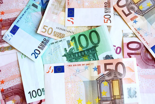 Euro und Banknoten — Stockfoto