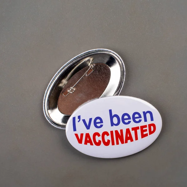 Vaccination campaign button pins on stone tabletop flat lay view
