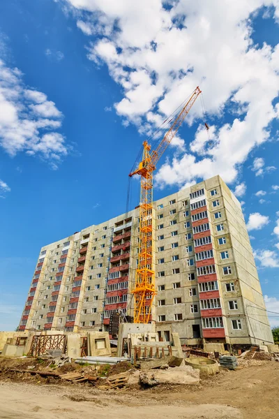 Dwelling house and tower crane on the construction site Stock Image