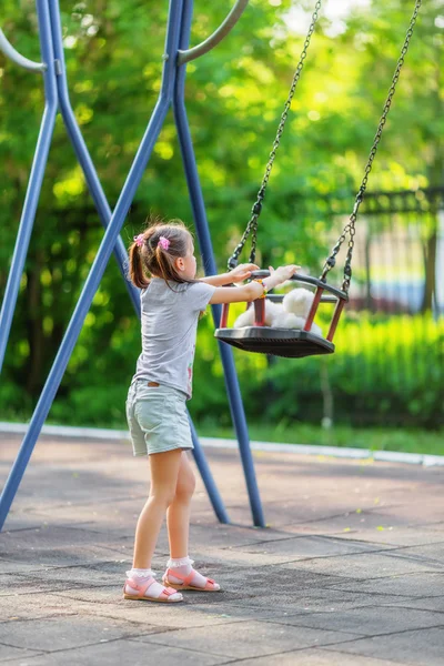 Little girl and seesaw — Stock Photo, Image