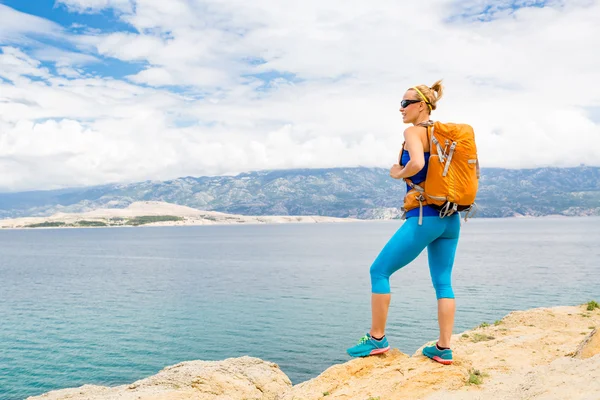 Deniz ve dağlar hiking kadın uzun yürüyüşe çıkan kimse ile sırt çantası, — Stok fotoğraf