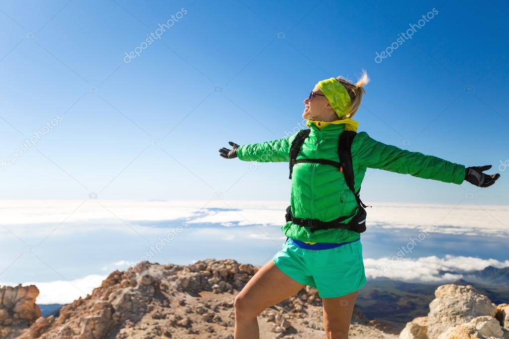 Woman hiking success climbing on mountain top Tenerife, Canary Islands