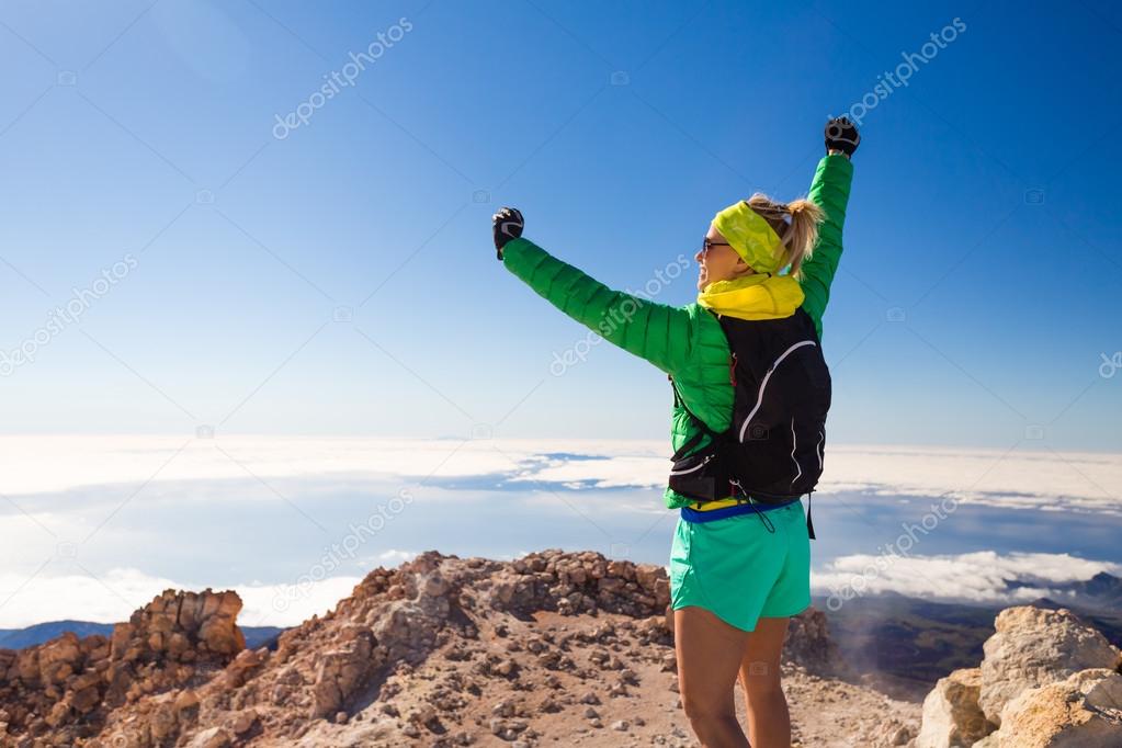 Hiking woman climbing in mountains on Teide Tenerife, Canary Islands