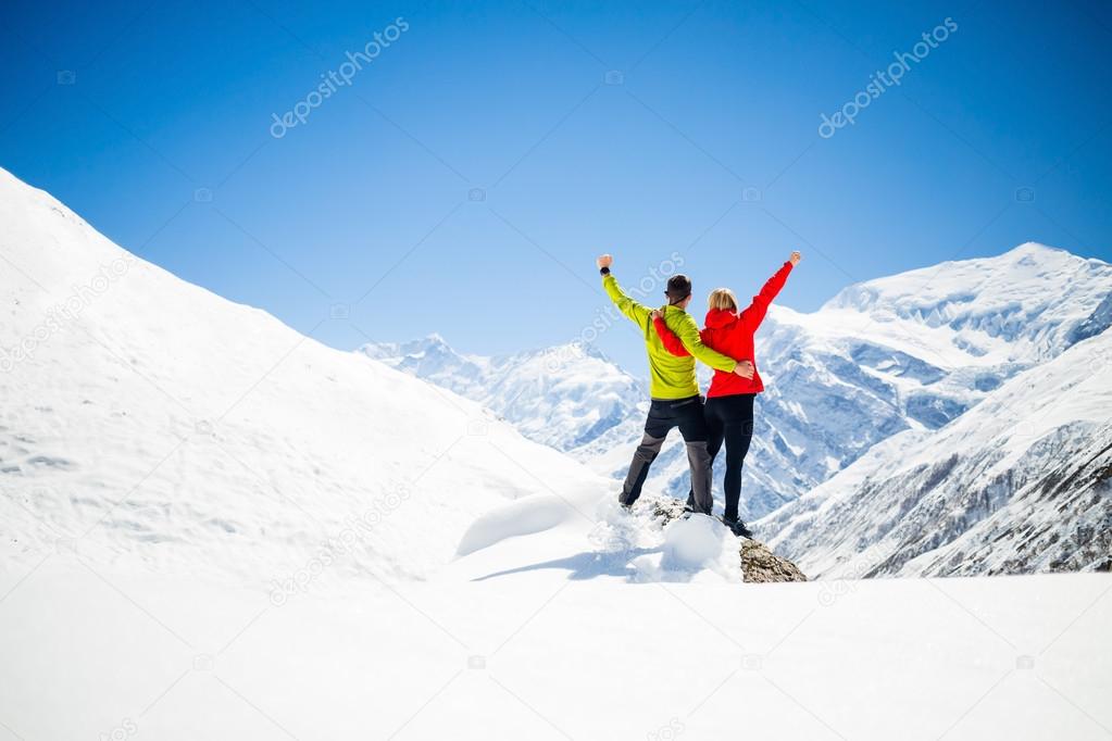 Couple hiking success in mountains