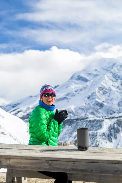 Mulher bebendo no acampamento base de montanha de inverno — Fotografia de Stock