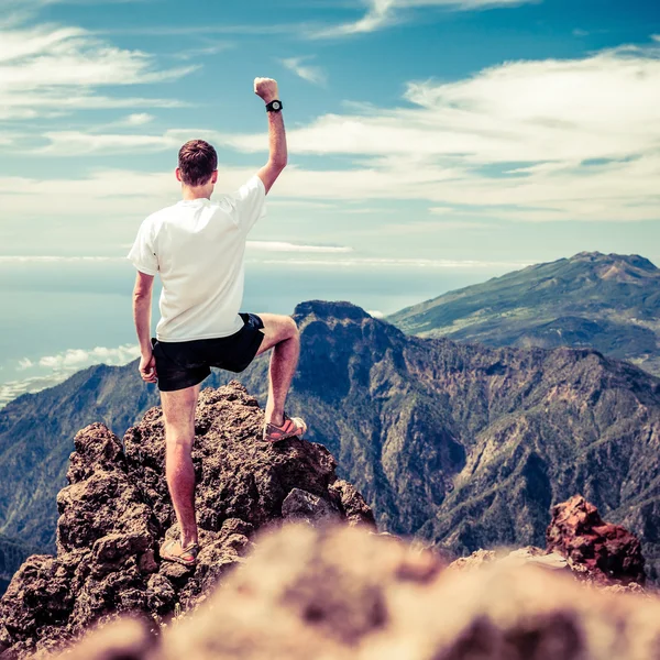 Trail runner success, man running in mountains