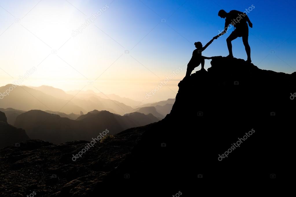 Teamwork couple hiking helping hand