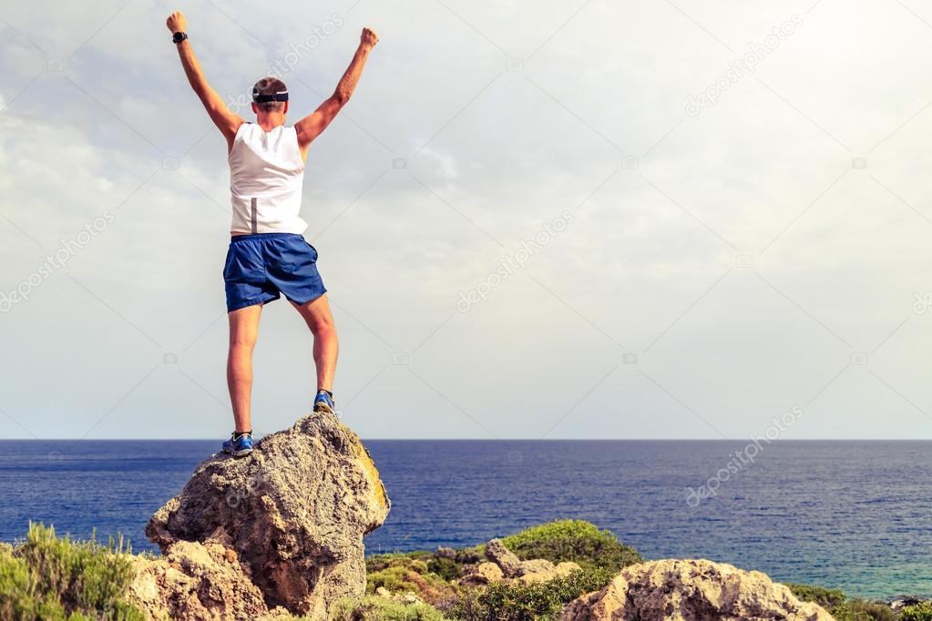 Happy climber runner reaching life goal success man