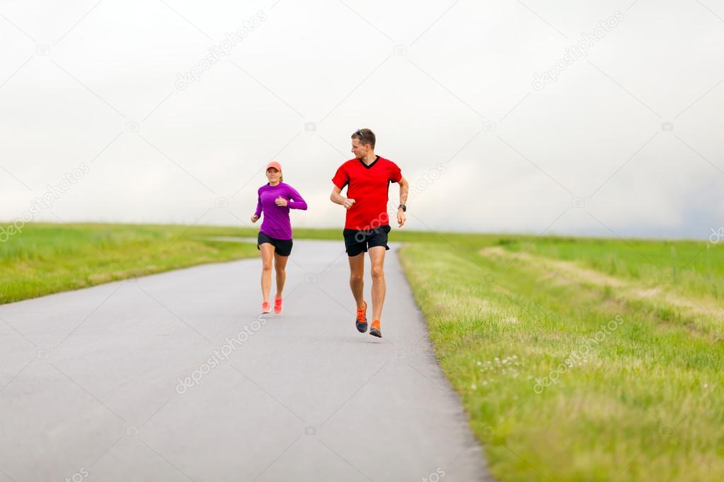 Couple running on country road