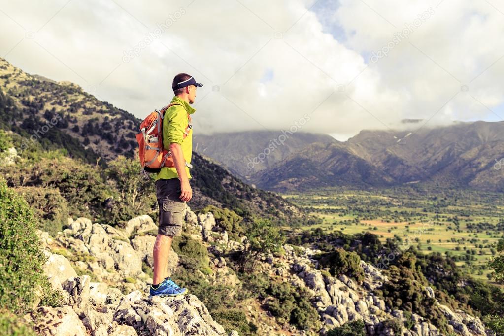 Hiking man looking at beautiful inspirational landscape