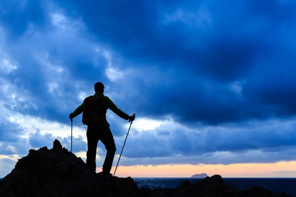 Wandelen silhouet backpacker kijken naar zonsondergang Oceaan — Stockfoto